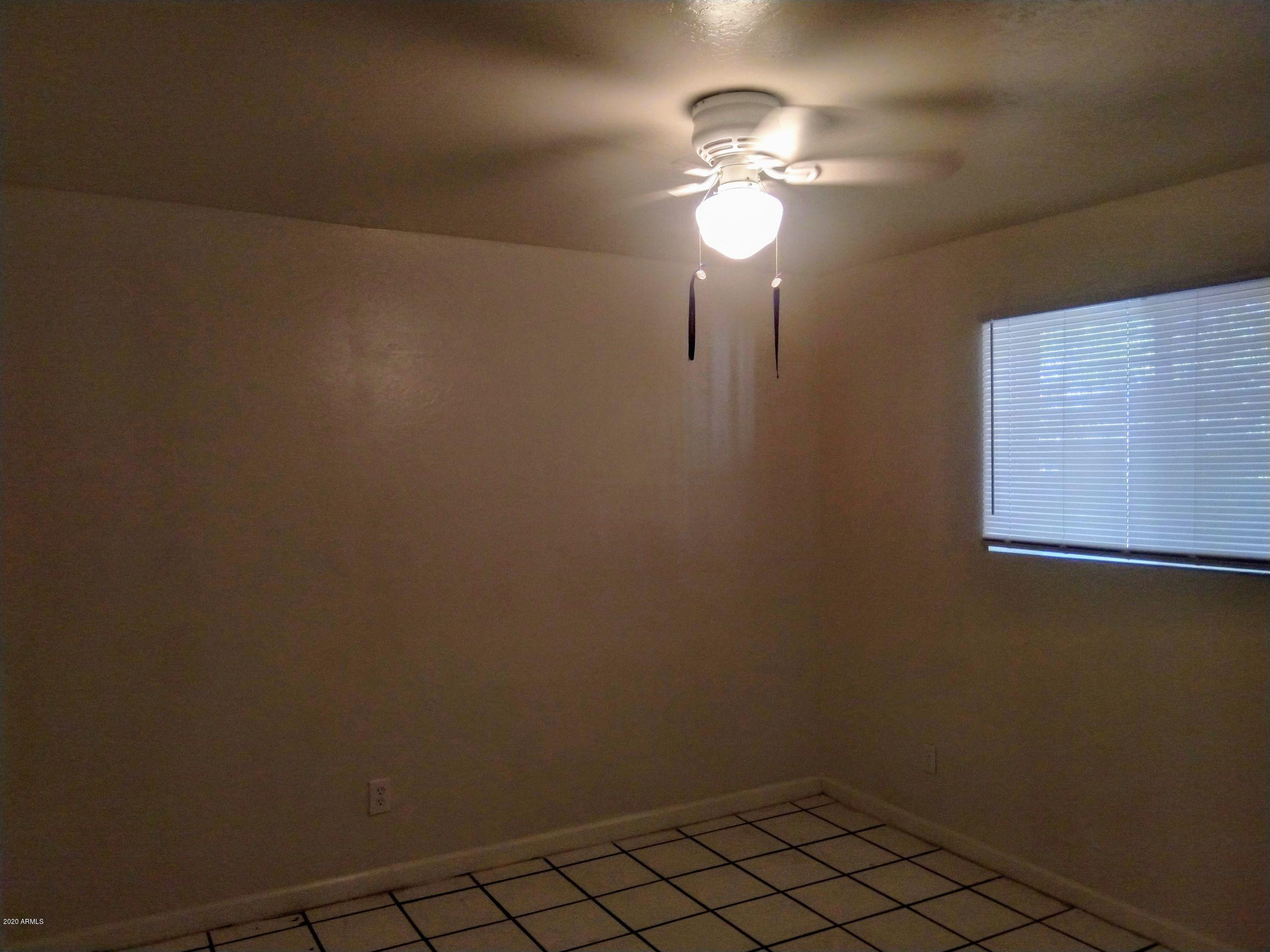 2133 West Adams Street, Unit 3 Phoenix, AZ 85009 - Photo 4 of 10 a view of a livingroom with a chandelier fan