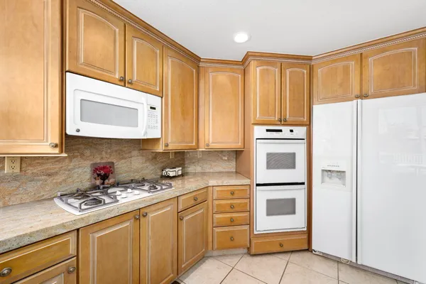 a kitchen with stainless steel appliances a refrigerator stove and sink