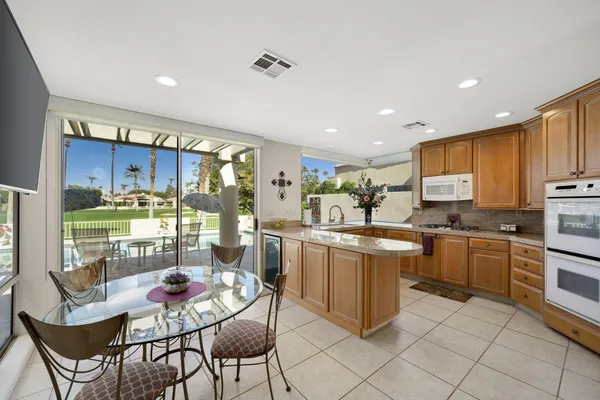 a kitchen with stainless steel appliances kitchen island granite countertop a sink and cabinets