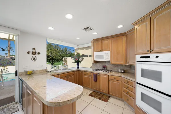 a kitchen with a sink stove and cabinets