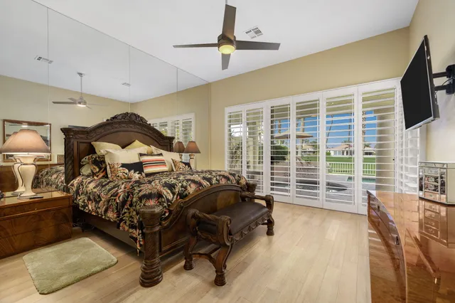 a bedroom with furniture and a flat screen tv