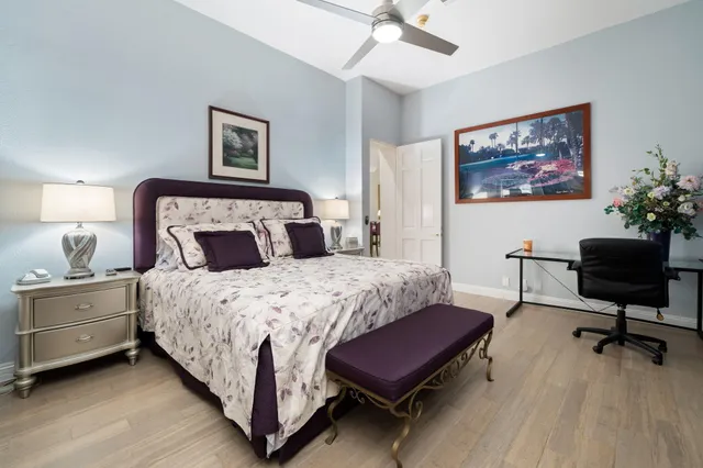 a bedroom with a bed and a chandelier