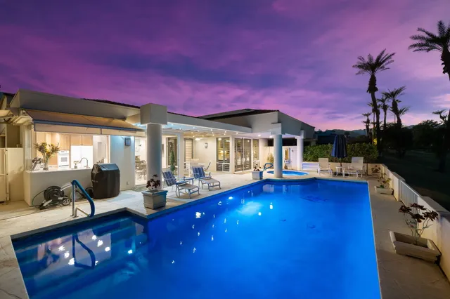 a view of swimming pool with outdoor seating