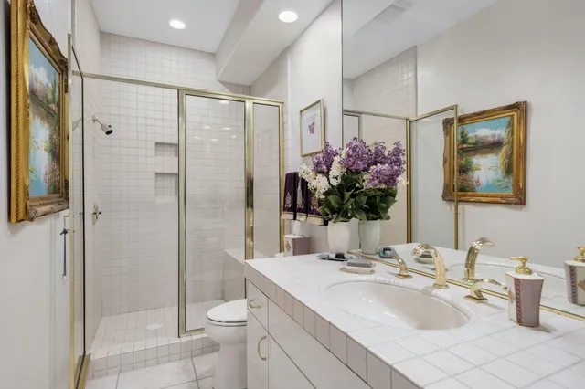 a bathroom with a sink toilet and shower