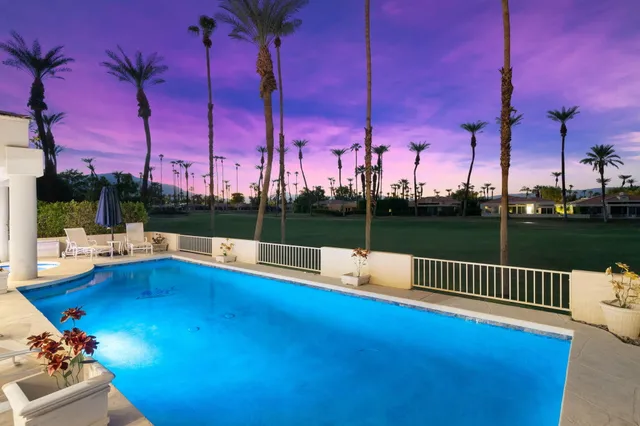 a view of a patio with a table chairs and a fire pit