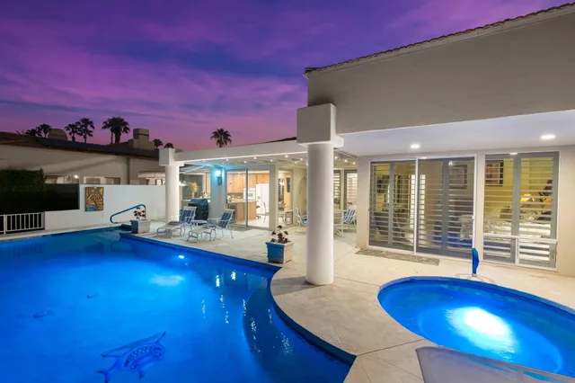 a living room with furniture and floor to ceiling window