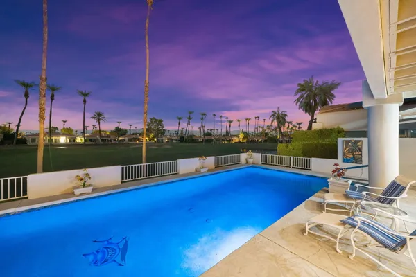a view of a swimming pool with a patio