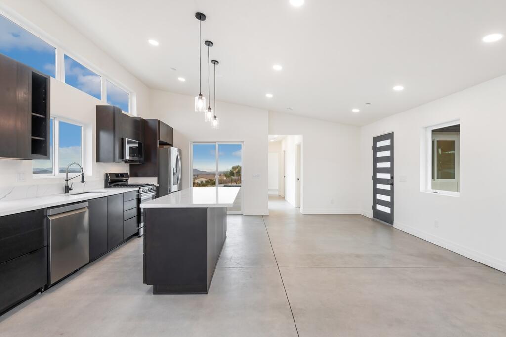 6689 Torres Avenue Joshua Tree, CA 92252 - Photo 16 of 48 a view of kitchen with stainless steel appliances kitchen island granite countertop a stove top oven a sink a counter top space and cabinets