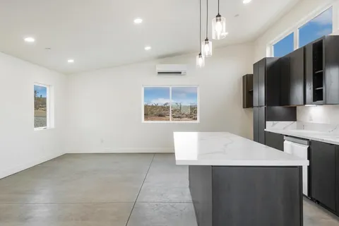 a kitchen with a sink a refrigerator and window