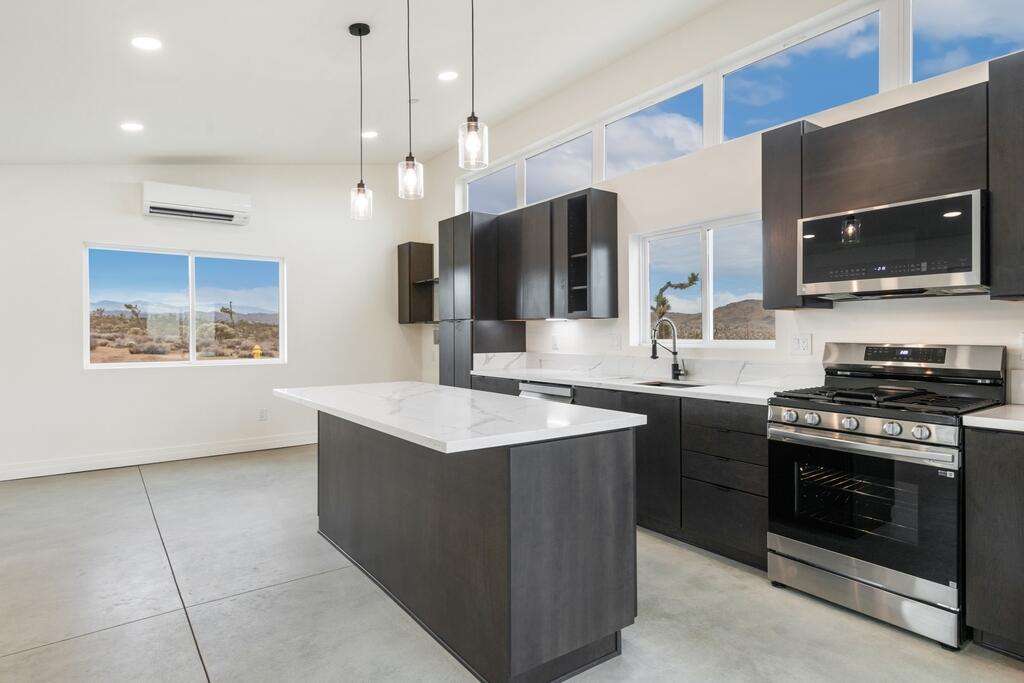 6689 Torres Avenue Joshua Tree, CA 92252 - Photo 19 of 48 a kitchen with stainless steel appliances a stove sink and microwave