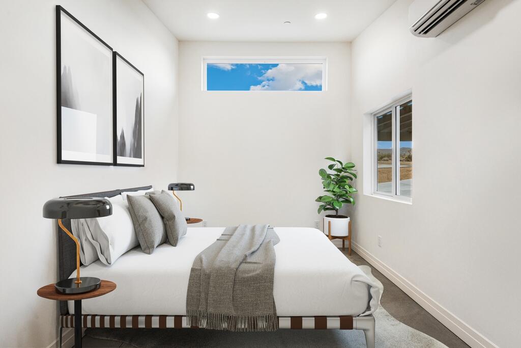 6689 Torres Avenue Joshua Tree, CA 92252 - Photo 27 of 48 a bedroom with a bed and a potted plant