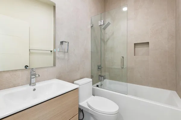 a bath tub sitting next to a white toilet