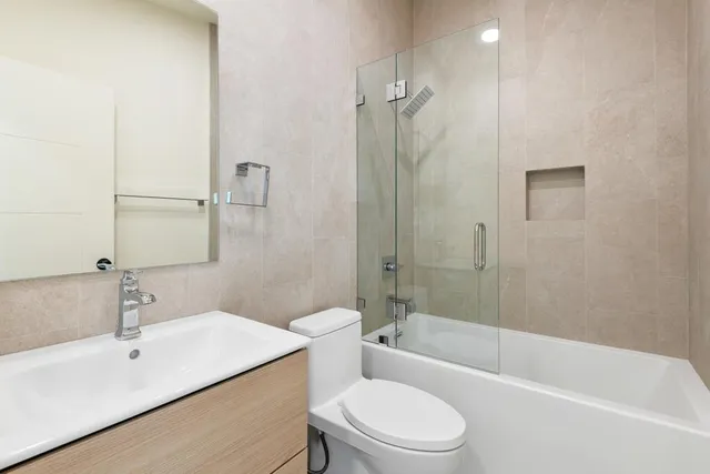 a bath tub sitting next to a white toilet