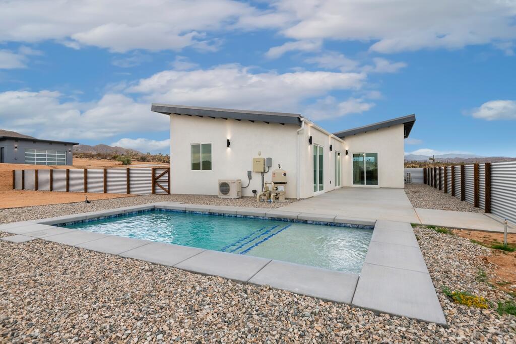 6689 Torres Avenue Joshua Tree, CA 92252 - Photo 39 of 48 a view of a house with backyard and sitting area