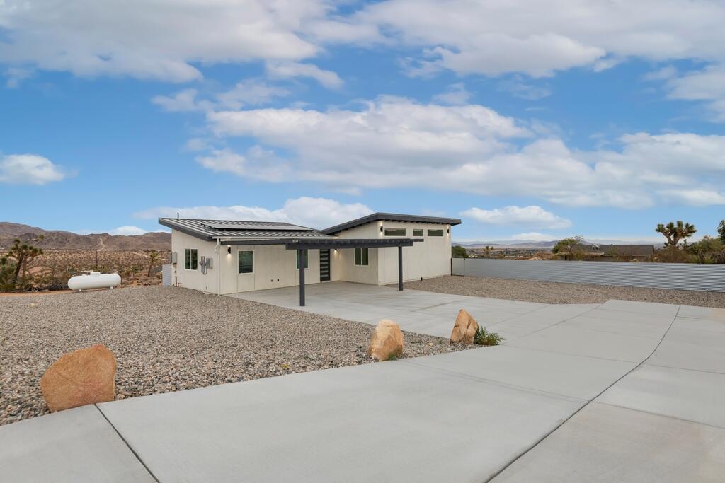 6689 Torres Avenue Joshua Tree, CA 92252 - Photo 4 of 48 a front view of a house with a yard and garage