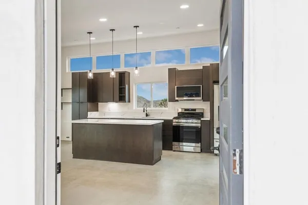 a kitchen with a refrigerator and a stove top oven