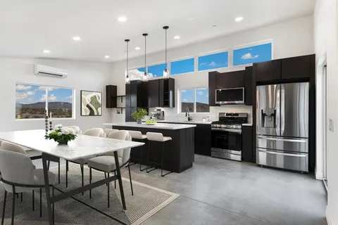 a kitchen with stainless steel appliances kitchen island granite countertop a refrigerator stove and oven