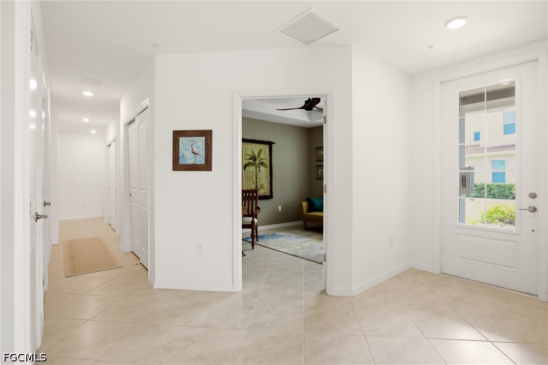 3751 Pebblebrook Ridge Court, Unit 101 Fort Myers, FL 33905 - Photo 34 of 48 a view of a hallway with wooden cabinets and a refrigerator