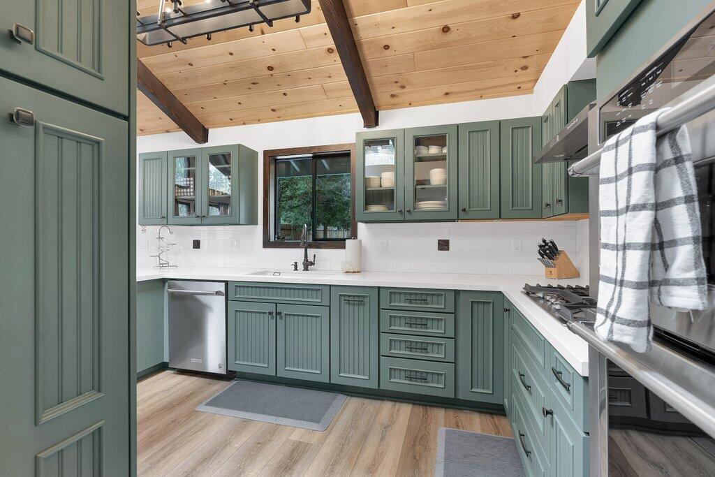 54495 South Circle Drive Idyllwild, CA 92549 - Photo 12 of 65 a kitchen with stainless steel appliances granite countertop a sink and wooden cabinets