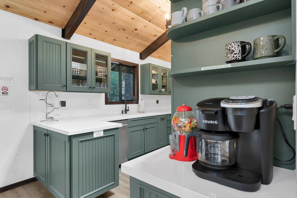 54495 South Circle Drive Idyllwild, CA 92549 - Photo 17 of 65 a kitchen with a sink dishwasher and a stove with a dining table