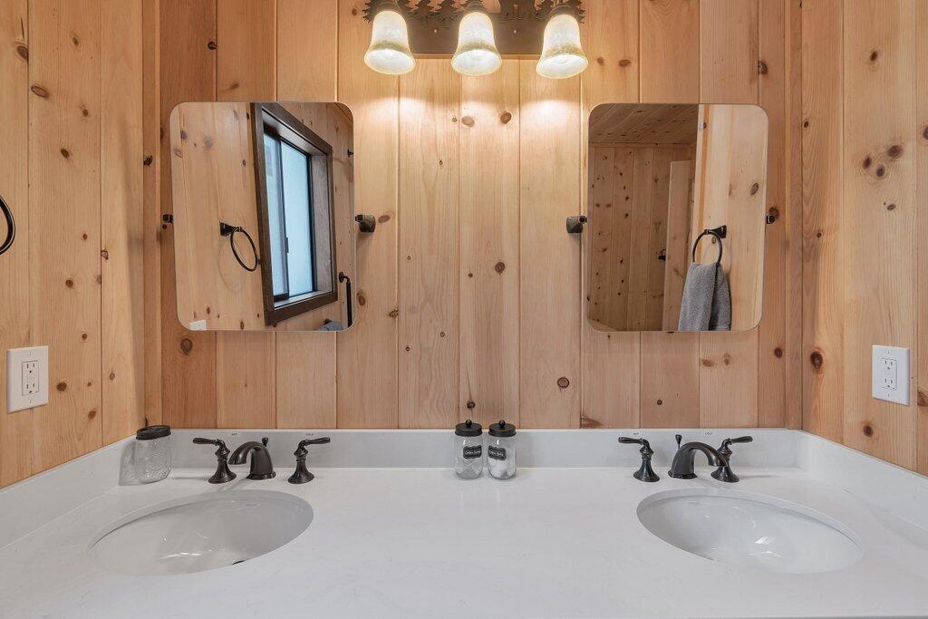 54495 South Circle Drive Idyllwild, CA 92549 - Photo 25 of 65 a bathroom with double vanity sinks and a mirror