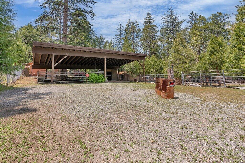 54495 South Circle Drive Idyllwild, CA 92549 - Photo 44 of 65 a view of patio with a table and chairs under an umbrella