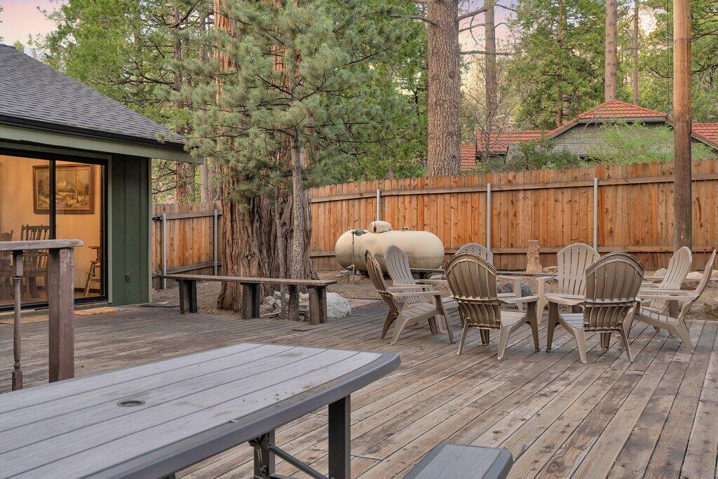 54495 South Circle Drive Idyllwild, CA 92549 - Photo 55 of 65 a view of a deck with table and chairs with wooden floor and fence