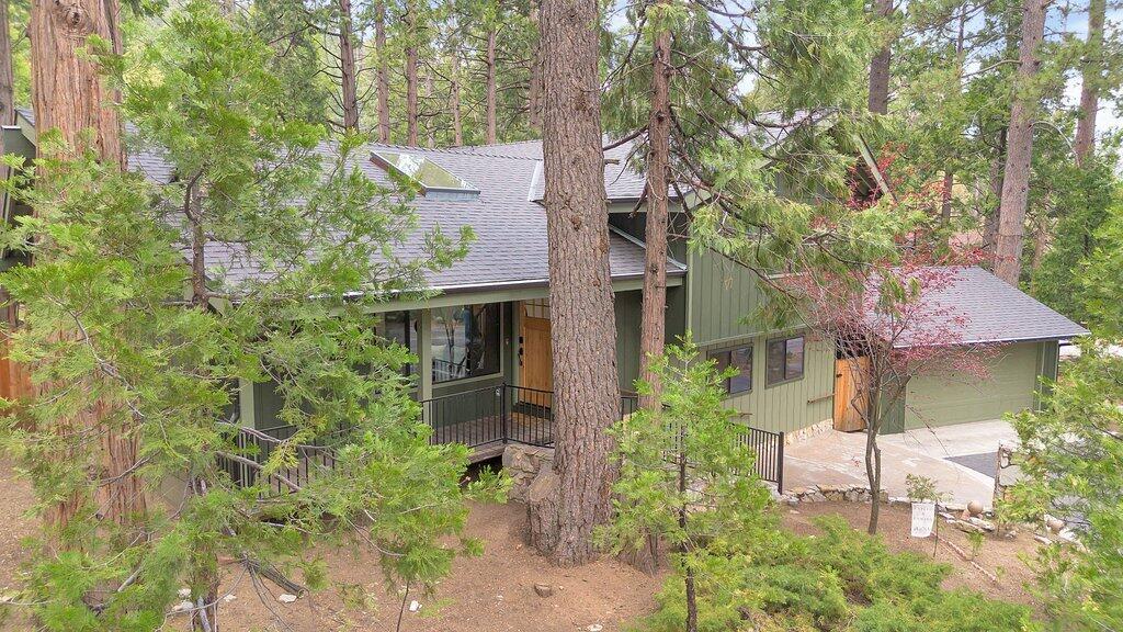 54495 South Circle Drive Idyllwild, CA 92549 - Photo 57 of 65 a front view of a house with plants and garden