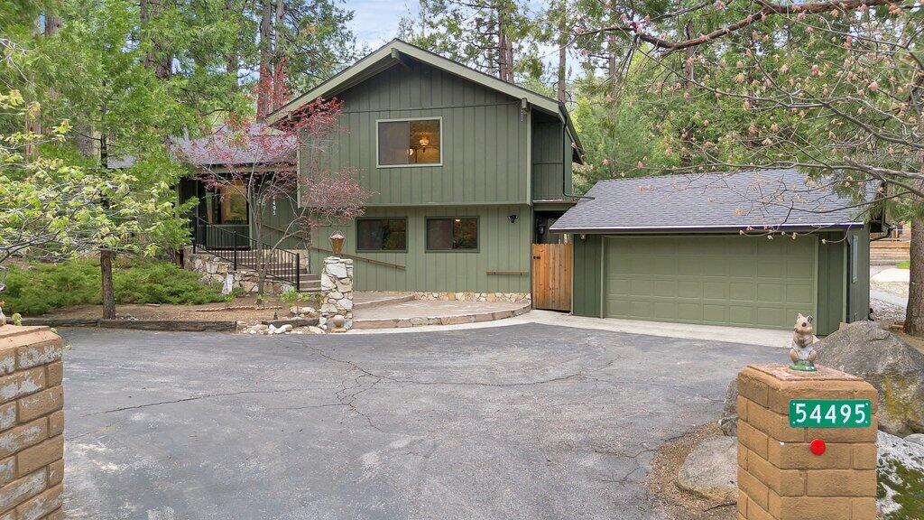54495 South Circle Drive Idyllwild, CA 92549 - Photo 60 of 65 a front view of a house with a yard and garage