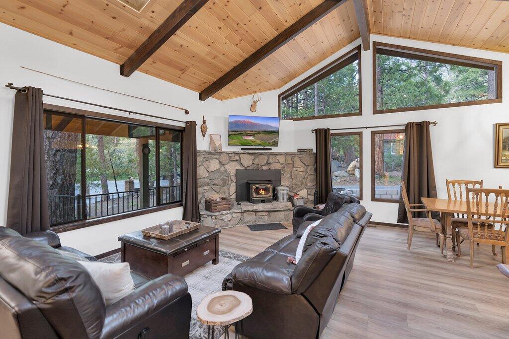 54495 South Circle Drive Idyllwild, CA 92549 - Photo 7 of 65 a living room with furniture a fireplace and a floor to ceiling window