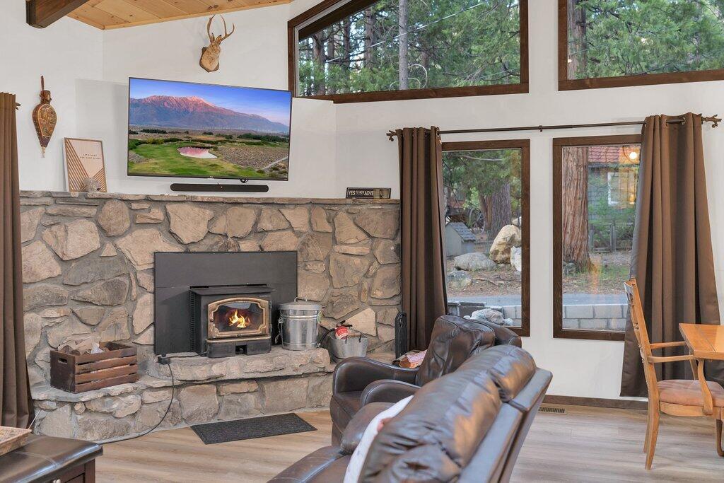 54495 South Circle Drive Idyllwild, CA 92549 - Photo 8 of 65 a living room with a fireplace and a floor to ceiling window