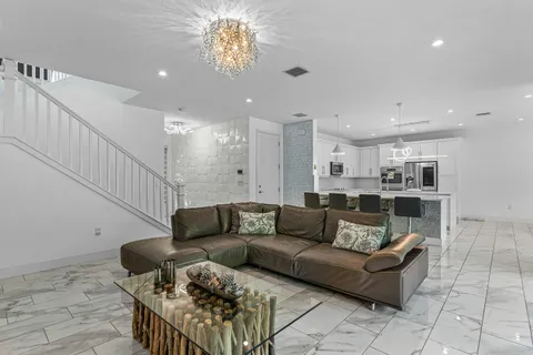 a kitchen with stainless steel appliances kitchen island granite countertop a sink and cabinets