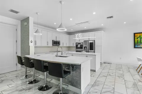 a dining room with furniture a chandelier and wooden floor