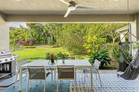 a front view of house with yard and trees in the background