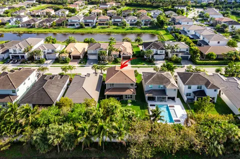 a kitchen with refrigerator and chairs