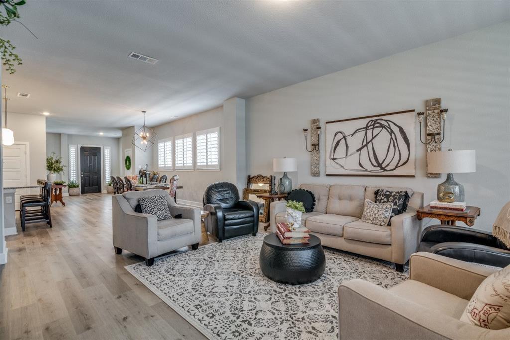 1268 Caprock Drive Forney, TX 75126 - Photo 11 of 35 a living room with furniture and a potted plant