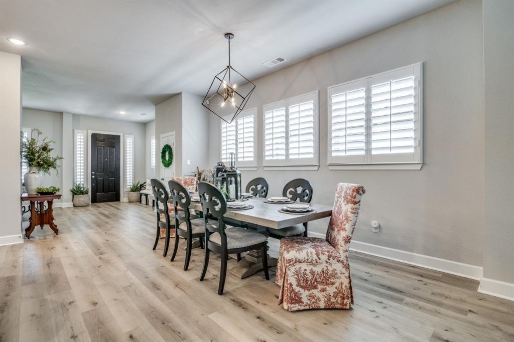 1268 Caprock Drive Forney, TX 75126 - Photo 15 of 35 a view of a a dining room with furniture window and wooden floor