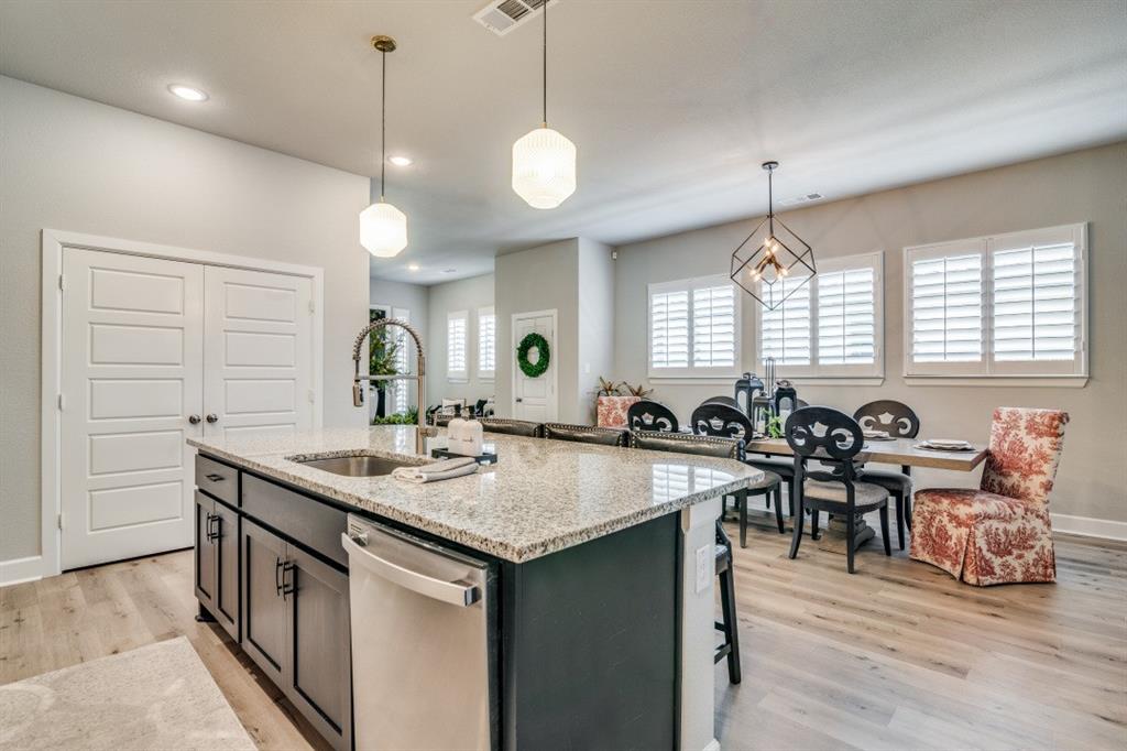 1268 Caprock Drive Forney, TX 75126 - Photo 18 of 35 a kitchen with lots of counter space sink and a refrigerator