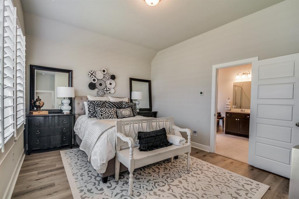 1268 Caprock Drive Forney, TX 75126 - Photo 22 of 35 a bedroom with a bed and a walk in closet