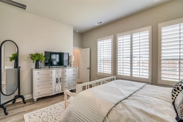a bedroom with a bed a table and chair