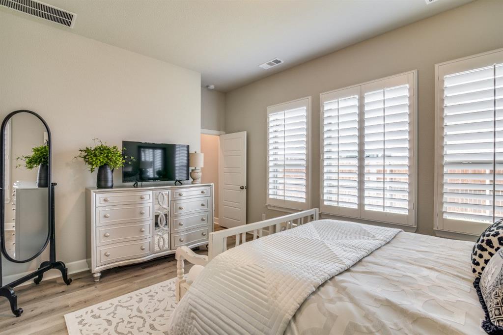 1268 Caprock Drive Forney, TX 75126 - Photo 24 of 35 a bedroom with a bed a table and chair