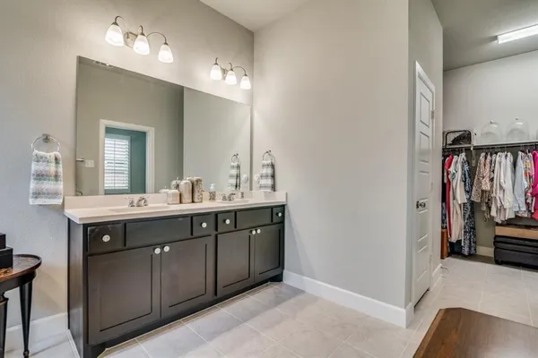 a spacious bathroom with a double vanity sink and a mirror