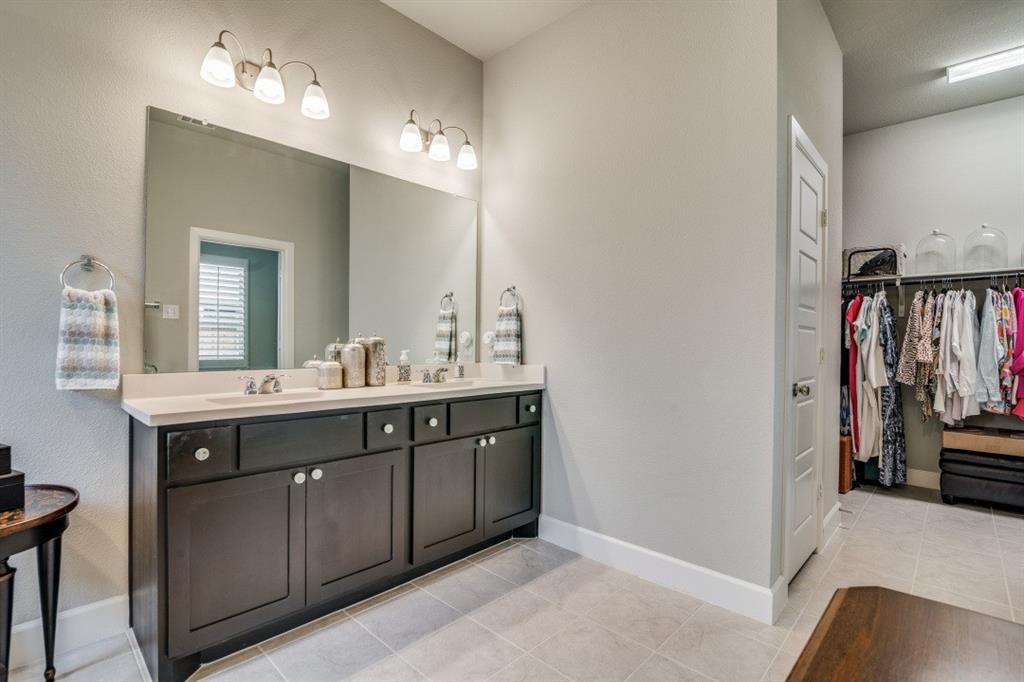 1268 Caprock Drive Forney, TX 75126 - Photo 26 of 35 a spacious bathroom with a double vanity sink and a mirror