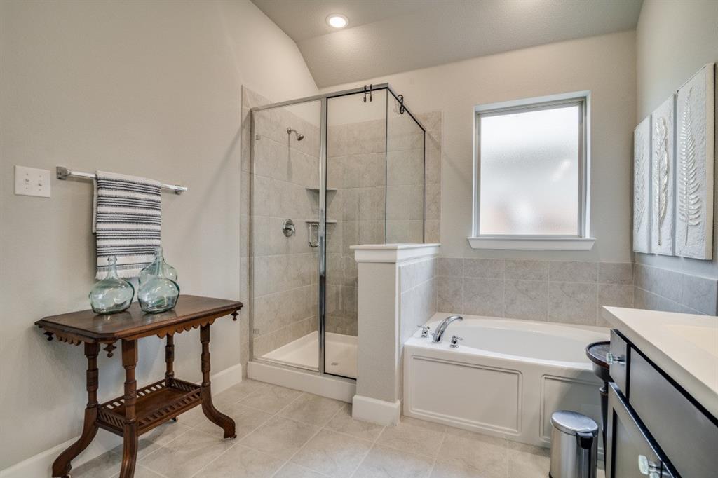 1268 Caprock Drive Forney, TX 75126 - Photo 27 of 35 a bathroom with a bathtub and a shower