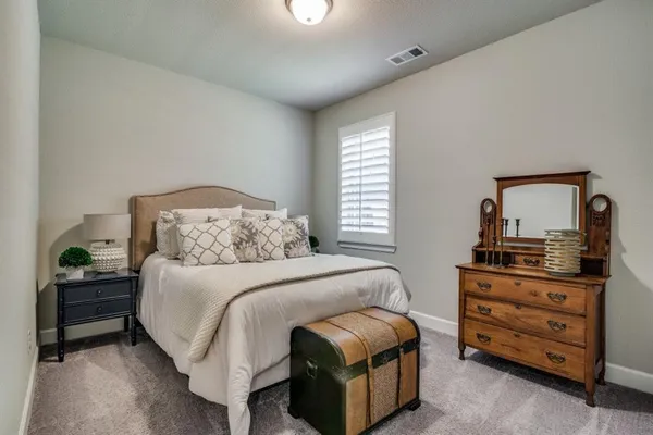 a bedroom with a bed and a dresser