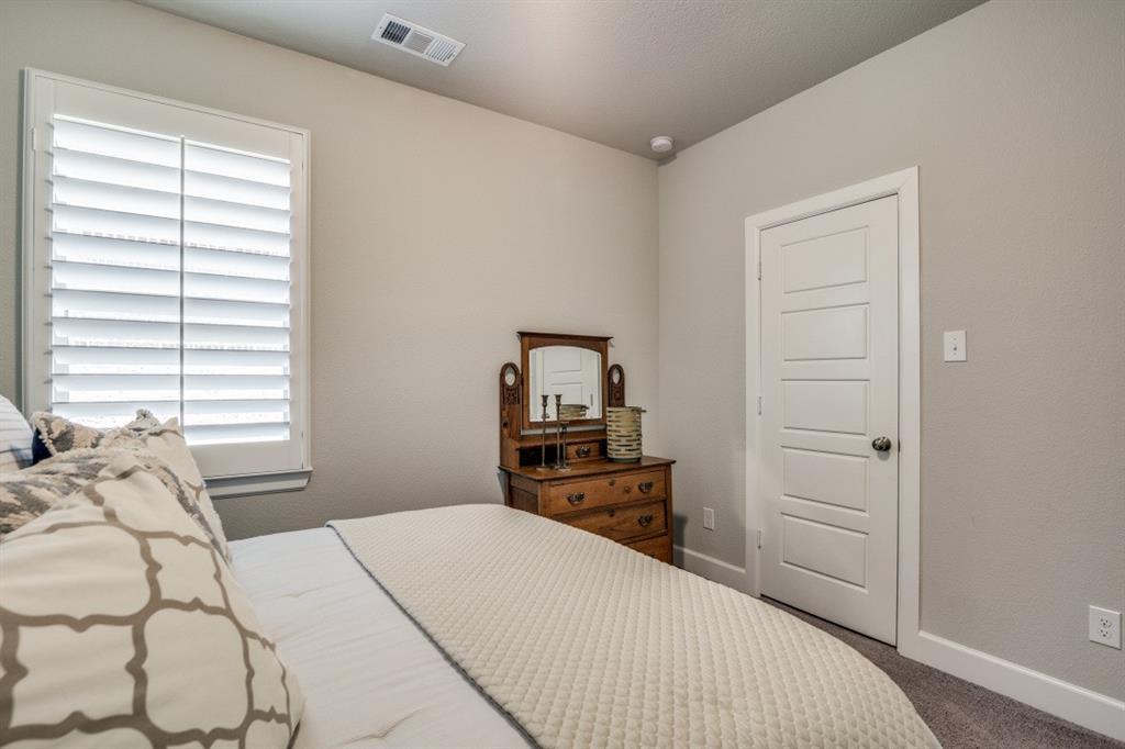 1268 Caprock Drive Forney, TX 75126 - Photo 29 of 35 a bedroom with a bed and a tv