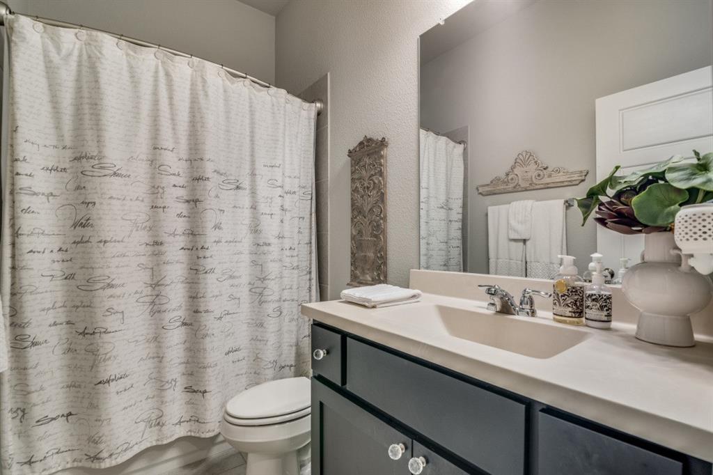 1268 Caprock Drive Forney, TX 75126 - Photo 30 of 35 a bathroom with a sink a toilet and a mirror