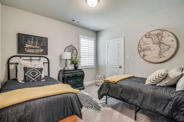a bedroom with a bed a lamp and a closet