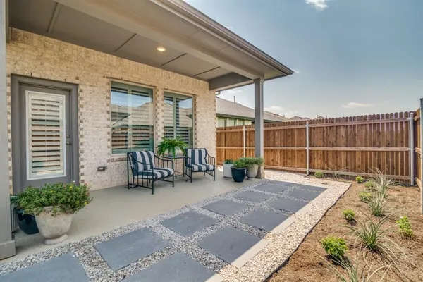 a view of a house with backyard sitting area and tub