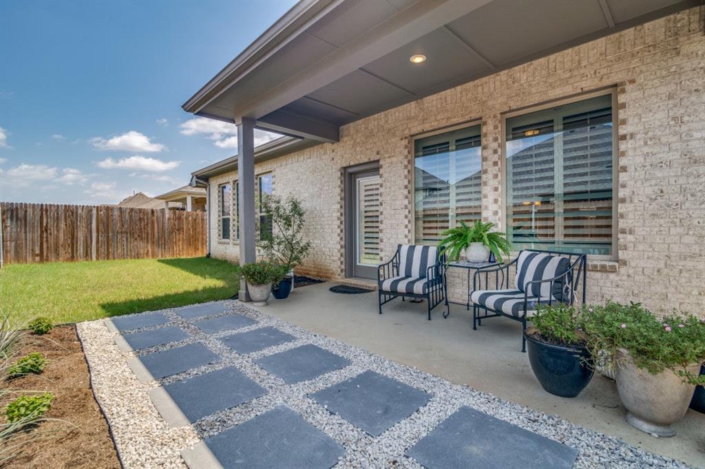 1268 Caprock Drive Forney, TX 75126 - Photo 35 of 35 a view of a patio with furniture and a garden